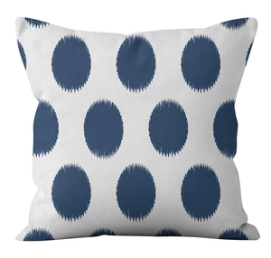 Detailed fabric texture of linen pillowcase featuring deep blue Ikat polka dot pattern