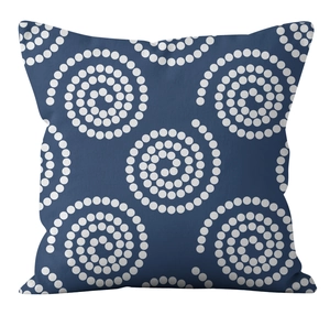 Detailed close-up of blue linen cushion cover with white dotted spiral geometric patterns