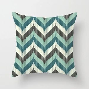 Macro shot of teal and mint green geometric wave pattern on a square cushion cover