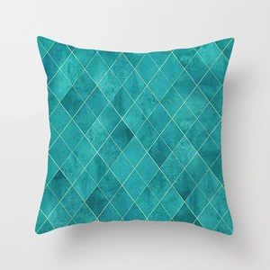Square teal geometric pillow cover with gold argyle pattern on a modern fabric texture