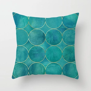 Macro detail of teal geometric pillow cover with elegant golden circular patterns