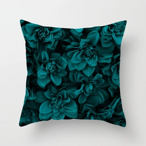 Detailed close-up of dark teal floral print on square decorative throw pillow cover