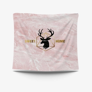 Detail of pink marble wall tapestry with golden geometric frame and reindeer head design