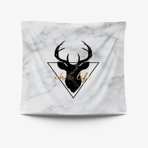 Detail of Nordic tapestry with marble pattern, reindeer silhouette and chic life gold text
