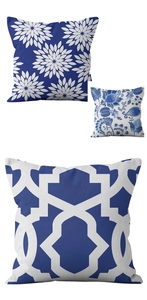 Detail of three blue and white pillow covers with floral and geometric patterns