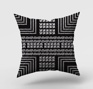 Detail of high-contrast black and white geometric pattern on modern square cushion cover