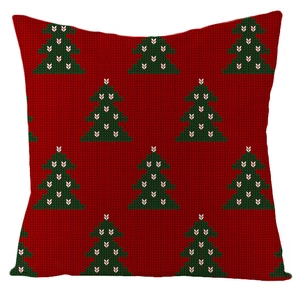 Close-up of a Christmas linen cushion cover with green tree patterns on a red background
