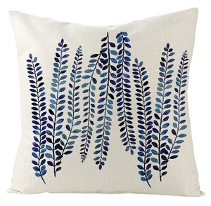 Close-up of blue botanical vine pattern on a square linen textured pillow cover