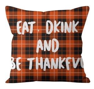 Macro shot of orange plaid pumpkin pillow cover with Eat Drink and Be Thankful text