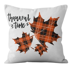 Detail of maple leaf buffalo plaid print and thankful time text on autumn pillow cover