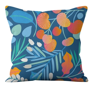 Detailed view of square pillow cover with botanical leaf prints on deep blue background