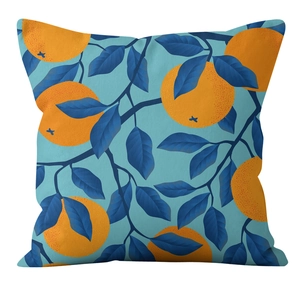 Detailed texture of square pillowcase with orange pattern and blue leaf print
