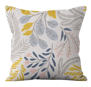 Detail of floral and leaf print on minimalist square cushion cover in soft gray and yellow
