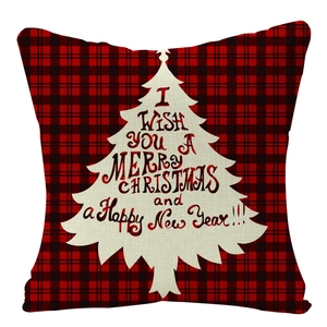 Detail of red and black buffalo plaid linen pillow cover with Christmas tree print
