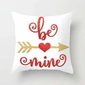 Close-up of Valentine pillow cover with red heart and golden arrow be mine text