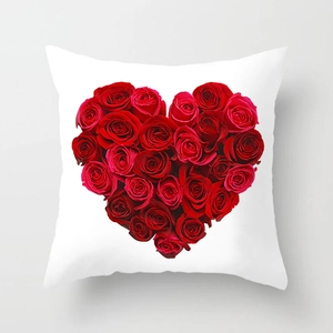 Detailed view of white throw pillow cover featuring a romantic red rose heart pattern
