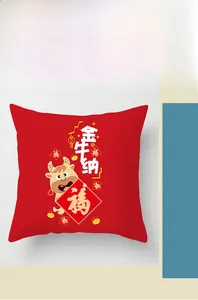 Detail of red festive pillowcase featuring cartoon lucky ox and New Year patterns