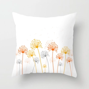Detail of white square cushion cover with bright orange and yellow floral patterns