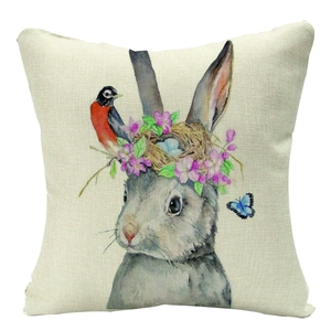Close-up of Easter linen pillow cover with watercolor rabbit, bird and flower pattern