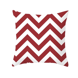 Detail shot of red and white chevron pattern on a minimalist geometric cushion cover
