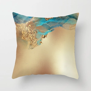 Detailed macro view of watercolor pillow cover with gold foil texture and teal fluid art