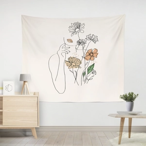 Close-up of minimalist line art tapestry with female silhouette and floral details