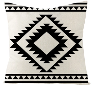 Close-up of bohemian black geometric patterns on a creamy white cotton linen pillow cover