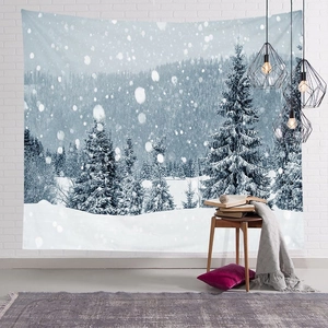 Detail of Nordic Christmas tapestry with snow forest hung on white brick wall