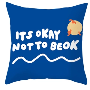Close-up of blue square cushion cover featuring white handwritten artistic font design