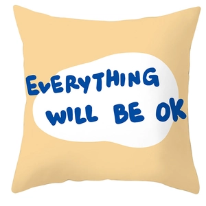 Detail of square pillowcase with orange base, geometric pattern and blue slogan text