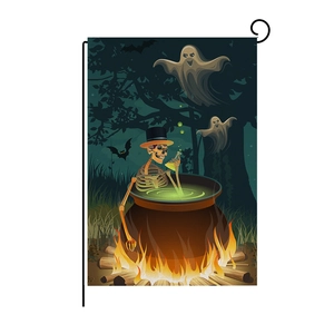 Close-up of linen Halloween garden flag featuring skull cooking over flames on black stand