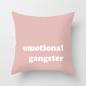 Macro shot of pink geometric pillow cover with white emotional gangster typography