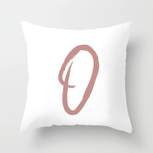 Close-up of square white pillowcase featuring a pink artistic letter O print