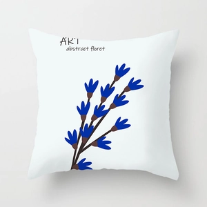 Detail view of square white cushion cover with blue abstract floral art and text