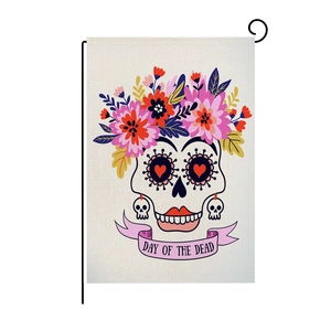 Detail of Day of the Dead garden flag showing sugar skull and linen texture on metal stand
