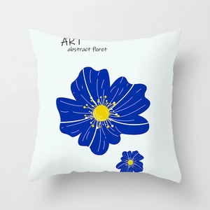 Detail of white throw pillow cover with blue abstract floral art and artistic lettering