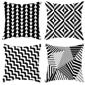Detail view of four black and white geometric pattern square pillowcase designs