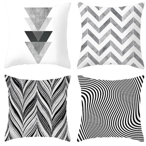 Detailed grid of four decorative pillow covers with diverse black and white geometric patterns