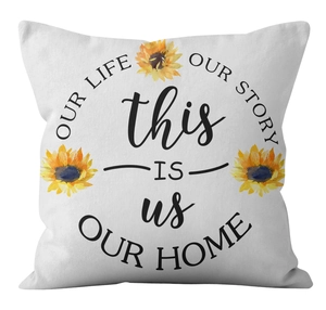 Detail view of sunflower print and English script on white square cushion cover