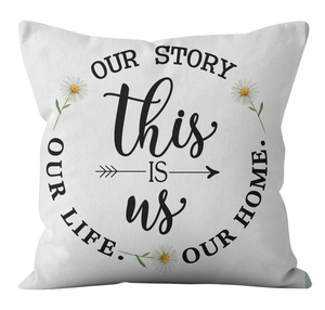 Detail showing white cushion cover fabric with 'Our Story' text and daisy floral prints
