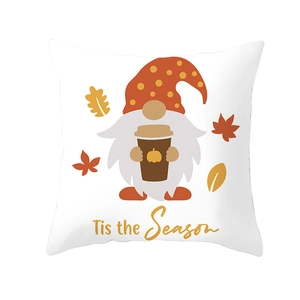 Detail showing festive gnome with coffee and Tis the Season text on white pillow cover