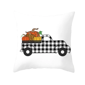 Close-up of checkered truck carrying pumpkins on a white harvest pillow cover