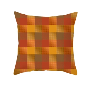 Detail of square Thanksgiving pillow cover with warm autumn orange and brown plaid pattern