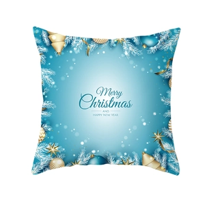 Detail of Christmas pillow cover featuring pine needles, ornaments, and holiday greeting