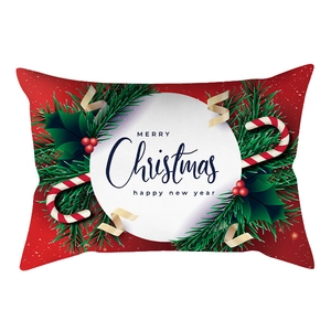 Close-up of red Christmas lumbar pillowcase with festive Merry Christmas print and holly motif