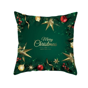 Detail of Christmas pillow cover with pine branches, ornaments and festive typography