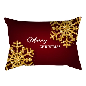 Detail of red Christmas lumbar pillow cover with golden snowflakes and Merry Christmas text
