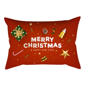 Macro detail of red Christmas lumbar pillow cover with gold snowflakes and festive motifs