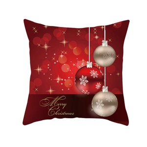 Detail of red Christmas pillowcase with hanging ornaments and golden Merry Christmas text