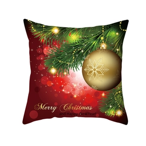 Close-up of a Christmas pillow case with a golden ornament and Merry Christmas text